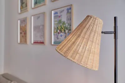 a lamp in a room with pictures on the wall at Romantic Suite Roig Arena N10 Virkin Suites in Valencia