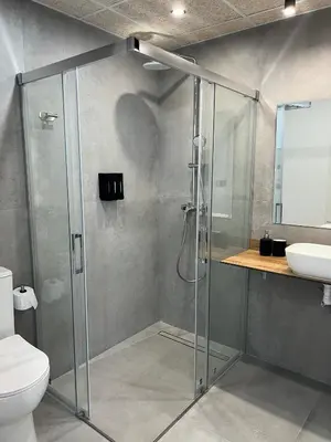 a bathroom with a shower and a toilet and a sink at Mistral Suites in Valencia