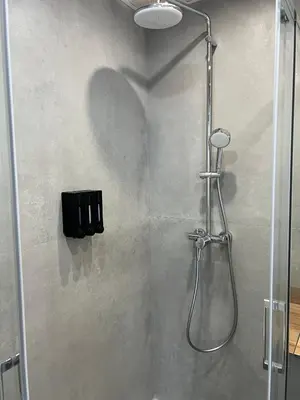 a shower with a glass door in a bathroom at Mistral Suites in Valencia