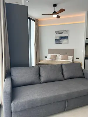 a living room with a couch and a bed at Mistral Suites in Valencia