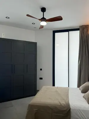a bedroom with a bed and a ceiling fan at Mistral Suites in Valencia