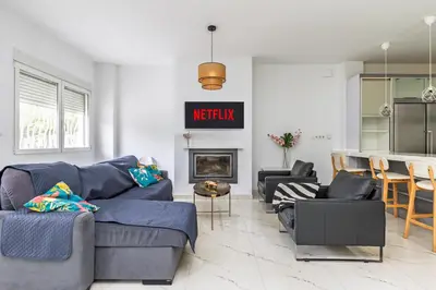 a living room with a blue couch and a fireplace at Casa Familiar 9 Pax, Smart TV, Centro, Playa, Café, AC in Valencia