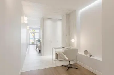 a white room with a desk and a chair at Exclusive beachfront apartment in Valencia