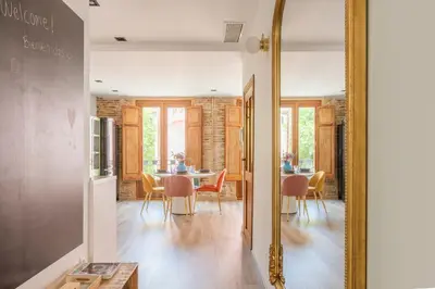 a dining room with a table and a mirror at Luxury new apartment 10 min walk to the beach, Late Checkout in Valencia
