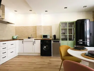 a kitchen with white cabinets and a washer and dryer at Luxury new apartment 10 min walk to the beach, Late Checkout in Valencia