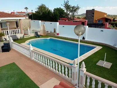 a swimming pool in a yard with a fence at Villa entre terre et mer in Montroy