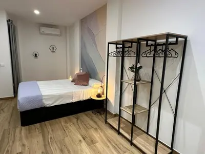a bedroom with a bed and a book shelf at La fonda de Olympia in Valencia