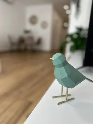 a green bird toy sitting on a table at La fonda de Olympia in Valencia