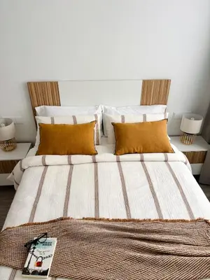 a bedroom with a large bed with orange pillows at Apartamento en Valencia Ruzafa in Valencia