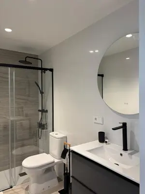 a bathroom with a toilet and a sink and a mirror at Apartamento en Valencia Ruzafa in Valencia