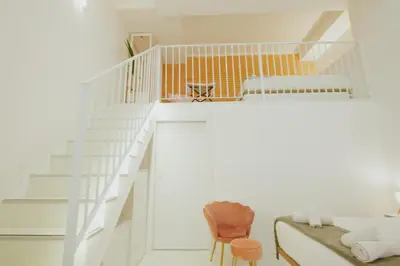 a white staircase in a white room with a chair at Apartment 2 City of Arts and Science Fast Wifi 2 in Valencia
