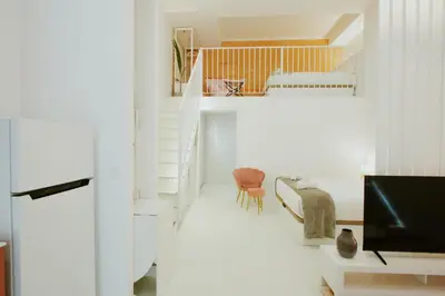 a living room with a staircase and a television at Apartment 2 City of Arts and Science Fast Wifi 2 in Valencia