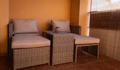 two chairs and a table in a room at La Luz de Lucia in Moncófar