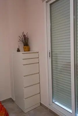 a bedroom with a dresser and a window at La Luz de Lucia in Moncófar