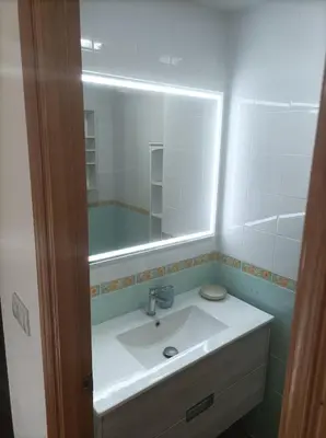 a bathroom with a sink and a mirror at Relax en familia junto al mar Les Palmeres in Sueca