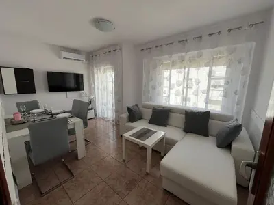 a living room with a couch and a table at Apartament Marina Cullera in Cullera