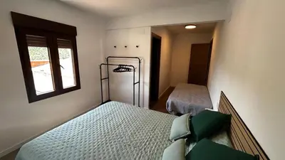 a bedroom with two beds and a window at Vistas del Frailecico in Chulilla