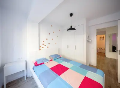 a bedroom with a bed with a colorful blanket at GuestReady - Homely escape in Valencia in Valencia