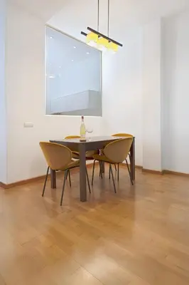 a dining room table and chairs in a white room at Grand Central Market Suites By VALENCIAFLATS EU in Valencia