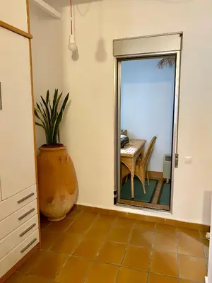 a dining room with a large vase and a table at Charming fisherman's house Cabanyal Cabañal in Valencia