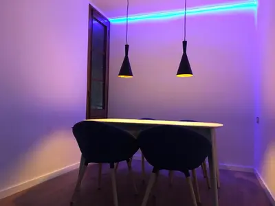 a dining room with a table with two chairs and lights at El Pilar Luxury Suites By VALENCIAFLATS EU in Valencia