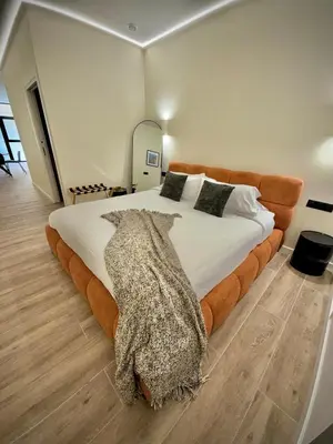 a bedroom with a large bed with a blanket on it at Tao Suite 1 next to the Aquarium in Valencia