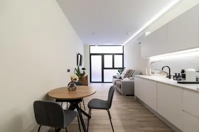 a kitchen and living room with a table and chairs at Tao Suite 1 next to the Aquarium in Valencia