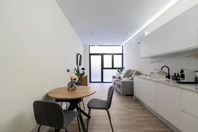 a kitchen and living room with a table and chairs at Tao Suite 2 next to the Aquarium in Valencia