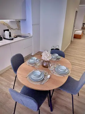 a dining room table with blue chairs and plates at Tao Suite 2 next to the Aquarium in Valencia