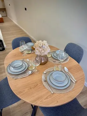 a wooden table with plates and wine glasses on it at Tao Suite 2 next to the Aquarium in Valencia