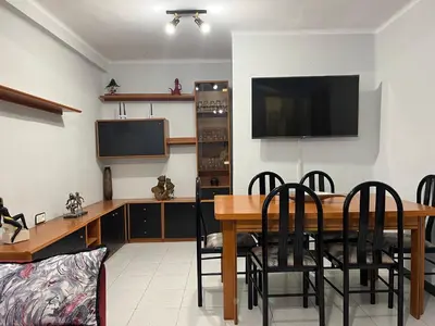 a dining room with a table and a flat screen tv at Apartamento Torres Serranos in Valencia
