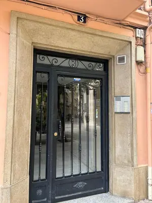 a black door of a building with wrought at Apartamento Torres Serranos in Valencia