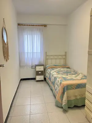 a bedroom with a bed and a dresser and a window at Apartamento Torres Serranos in Valencia