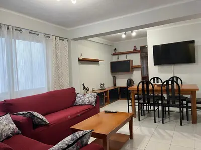 a living room with a red couch and a table at Apartamento Torres Serranos in Valencia