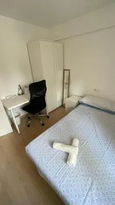 a bedroom with a bed and a desk and a chair at Flat close to beach perfect for families and groups - Isidro B 3 in Valencia