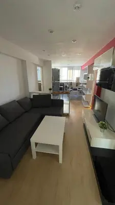 a living room with a couch and a table at Flat close to beach perfect for families and groups - Isidro B 3 in Valencia