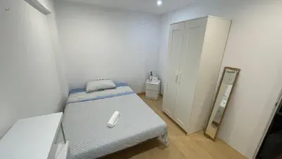 a small room with a bed and a mirror at Flat close to beach perfect for families and groups - Isidro B 3 in Valencia