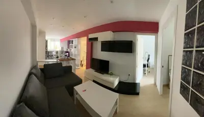 a living room with a couch and a table in a room at Flat close to beach perfect for families and groups - Isidro B 3 in Valencia