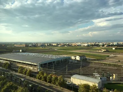 a large building with a field and a city at Panoramic Suites By VALENCIAFLATS EU in Valencia