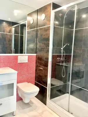 a bathroom with a toilet and a shower at Panoramic Suites By VALENCIAFLATS EU in Valencia