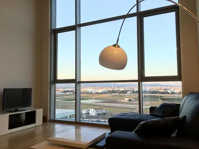 a living room with a large window and a couch at Panoramic Suites By VALENCIAFLATS EU in Valencia
