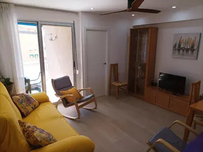 a living room with a yellow couch and chairs at Marti, 7-38 in Cullera