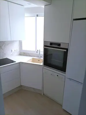 a white kitchen with a sink and a microwave at Marti, 7-38 in Cullera