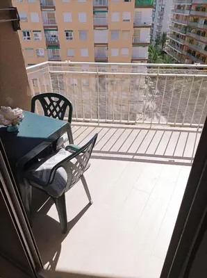 a balcony with a table and a chair on a balcony at Marti, 7-38 in Cullera