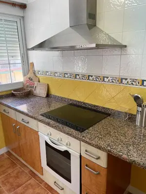 a kitchen with a stove top oven next to a window at Apartment on Sueca Beach Mis Gaviotas in Mareny Barraquetas