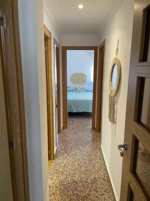 a hallway with a room with a bed and a mirror at Apartment on Sueca Beach Mis Gaviotas in Mareny Barraquetas