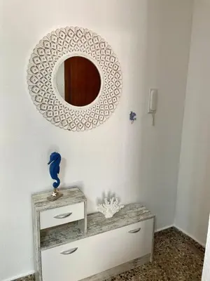a mirror on a wall above a dresser in a room at Apartment on Sueca Beach Mis Gaviotas in Mareny Barraquetas
