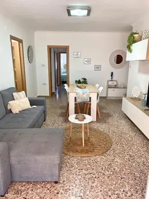 a living room with a couch and a table at Apartment on Sueca Beach Mis Gaviotas in Mareny Barraquetas