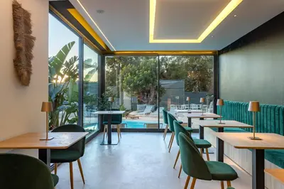 a restaurant with tables and chairs and a large window at Resort Serra Nature - Luxury Villas Hotel Boutique in Serra