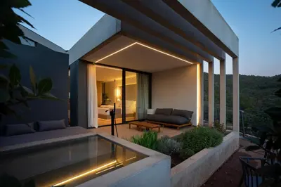 a house with a patio with a couch and a table at Resort Serra Nature - Luxury Villas Hotel Boutique in Serra